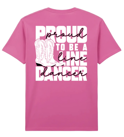 A pink short-sleeve t-shirt shown from the back, featuring a white graphic print with the text 'PROUD TO BE A LINE DANCER' and an illustration of cowboy boots.
